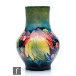 A Moorcroft vase of globe and shaft form decorated in the Leaf and Berry pattern, impressed
