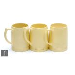 Three Keith Murray for Wedgwood Matt Straw tankards with horizontal bands to the foot, printed
