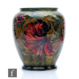 A Moorcroft vase of swollen footed form decorated in the Spanish pattern, impressed Burslem mark