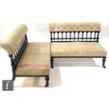 A pair of late 19th Century ebonised two seater settees on turned feet to the front below a