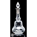 An early 20th Century clear crystal decanter, of wrythen gourd form with silver hallmarked frilled