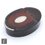 A late 18th Century oval papier mache snuff box, the hinged cover inset with a silver engraved panel