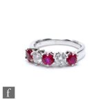 An 18ct white gold ruby and diamond five stone ring, three rubies spaced by diamonds each