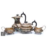 A hallmarked silver four piece tea set of plain boat shaped panelled form, each raised on four