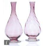 A pair of 20th Century glass vases, of ovoid form with tall tapering necks, the body with internal