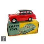 A Corgi 216M Austin A40 Saloon diecast model in red with black roof, silver trim, flat spun hubs and