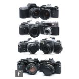 A collection of various cameras and lens, to include Olympus OM40, OM-2 x2 (chrome and black