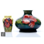 Two Moorcroft Pottery vases, the first decorated in the Hibiscus pattern against a green wash