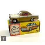 A Corgi 231 Triumph Herald Coupe in two-tone white and gold with red interior, silver trim and