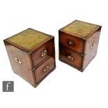 A pair of late 20th Century reproduction mahogany campaign style chests, the two drawers applied