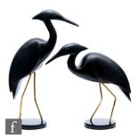 A pair of ebonised Egrets each standing on a circular base, by Feathers Gallery South Africa, the