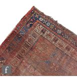 An early 20th Century flat woven Baluch rug, the central field decorated with three medallions
