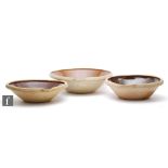 Three large Danish mixing bowls each glazed in brown to the interior, unmarked, largest diameter