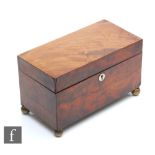 A late Regency period mahogany tea caddy raised to brass ball feet, twin section interior, lacking