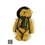 A Steiff miniature articulated pewter teddy bear, replica of Scottish Bear, wearing hat and scarf,