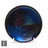 A small mid 20th Century pin dish, of circular form with abstract enamelled decoration in tones of