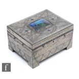 An Arts and Crafts work box with pewter repousse work over a wooden carcass, with central enamel