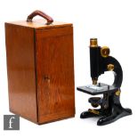 An early 20th Century microscope by Beck London, model 29, in oak case, with two spare lenses,