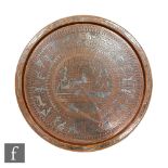 A large early 20th Century copper and white metal decorated circular tray decorated with an Egyptian