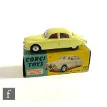 A Corgi 208S Jaguar 2.4 Litre Saloon diecast model with lemon body, red interior, silver trim and