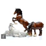 Three Beswick horses comprising a Shire Mare (Lying) model 2459, printed circular mark, restored,
