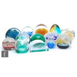 A collection of assorted 20th Century glass paperweights of various forms and decorations, to