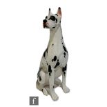 A large ceramic model of a seated Great Dane, painted in black and white colourway, height 100cm.