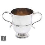 A hallmarked Queen Anne Britannia standard silver loving cup, rising from a spreading circular