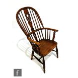 A 19th Century Windsor armchair, with ash hoop, arm rails and spindles centred by a pierced beech
