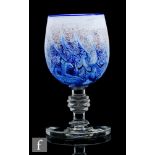 A large contemporary studio glass goblet, the ovoid bowl decorated with mottled blue and white swirl