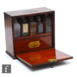 A late 19th Century apothecary cabinet, the double sided divisions containing various glass jars,