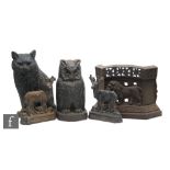 A cast iron door stop of an owl, another of a seated cat, a pair of stags and a similar example of a