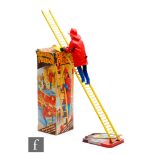 A 1950s Louis Marx & Co. 'Climbing Fireman' tinplate and plastic clockwork toy, No. 735, with