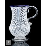 An 18th Century glass ale tankard, circa 1780-1800, of footed baluster form decorated with pulled