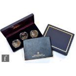 An Elizabeth II set of four 2003 famous world silver coin collection, a cased set of three Duke of