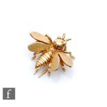 A 9ct lapel pin modelled as a bee with matt finish effect to wings, weight 2.7g, length 18mm,