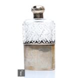 A hallmarked silver and clear cut glass hip flask, silver sleeve below hob nail cut body, screw top,
