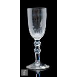 An 18th Century ale glass circa 1820, with funnel bowl with basal petal moulded fluting, over a