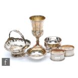 Five items of hallmarked silver a pair of napkin rings, a tea strainer and stands, a Kiddish cup and