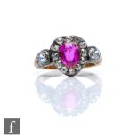 An early 19th Century ruby and diamond cluster ring, central oval ruby, length 6mm, within a
