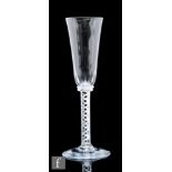 An 18th Century ale glass circa 1750, the tall round funnel bowl above an annulated collar and