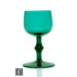 An 18th Century Bristol green drinking glass circa 1755, the ovoid bowl above an incised stem with