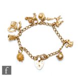 A 9ct hallmarked open curb link charm bracelet with eight charms attached, total weight 23g,