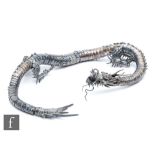An early 20th Century white metal study of an articulated Japanese dragon with two claws to each