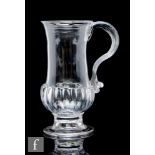An 18th Century glass tankard, circa 1750-1760, with gadrooned base and spiral ribbing to the top of