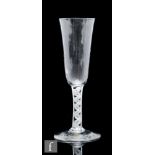 An 18th Century ale glass circa 1765, with elongated round funnel bowl with moulded basal flutes,