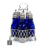 An 18th Century hallmarked silver condiment stand with five bottles, the Bristol blue bottles