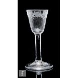 An 18th Century drinking glass circa 1750, the round funnel bowl with basal fluting and engraved