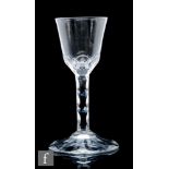 An 18th Century Jacobite drinking glass circa 1775, the round funnel bowl facet cut to the base to