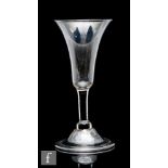 An 18th Century balustroid drinking glass circa 1740, the slender flared trumpet bowl above a